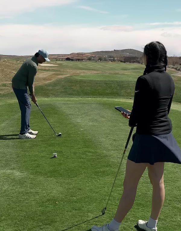 golf instructor with student